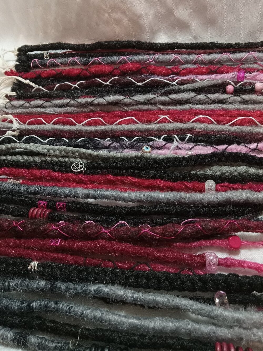 A full head of dreadlocks and braids, handmade from soft synthetic materials